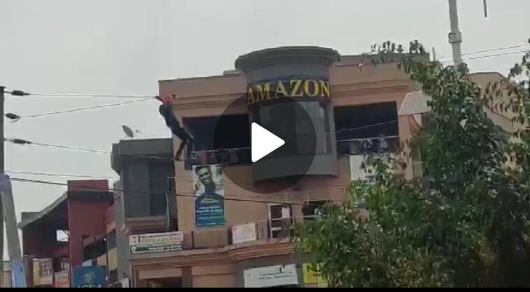VIDEO: Shock! Man in Mbarara climbs on electric wires alongside streets