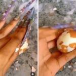 VIDEO: Watch as slay queen struggles to peel an egg with long nails