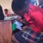 Video: University female student filmed eating a bucket of food in class